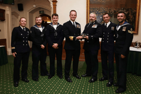 A helicopter crew that destroyed several drones operated by Houthi rebels were honoured at a Royal Navy awards evening. They were deployed with Portsmouth-based warship HMS Diamond in the Red Sea. Pictured are Vengeance 4 Flight receive the Sopwith Pup Trophy from Rear Admiral Anthony Rimmington.