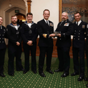 A helicopter crew that destroyed several drones operated by Houthi rebels were honoured at a Royal Navy awards evening. They were deployed with Portsmouth-based warship HMS Diamond in the Red Sea. Pictured are Vengeance 4 Flight receive the Sopwith Pup Trophy from Rear Admiral Anthony Rimmington.