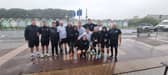 Stephen Hore (far right) and the United Minds runners celebrate finishing The Great South Run just as the worst of the weather hits. 