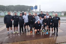Stephen Hore (far right) and the United Minds runners celebrate finishing The Great South Run just as the worst of the weather hits. 
