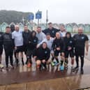Stephen Hore (far right) and the United Minds runners celebrate finishing The Great South Run just as the worst of the weather hits. 