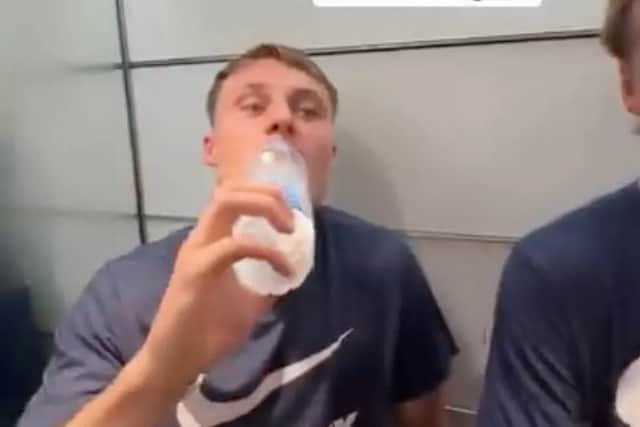 Owen Moxon swigs from a bottle of water as Pompey's players get stuck in a lift ahead of their weekend win at QPR. Pic: Tom McIntyre Instagram (tom5mc).