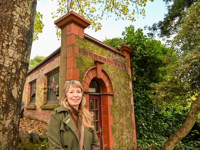 Loz Samuels pictured outside the world's smallest theatre - a former public loo in Malvern, UK.