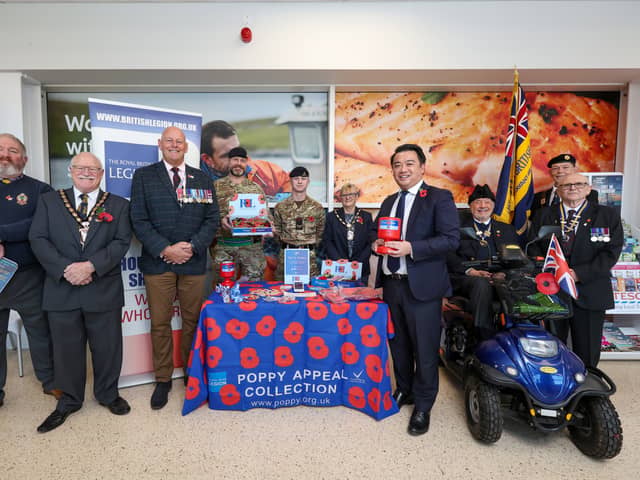 The Havant Poppy Appeal has been launched, with a call for residents to get behind the cause once again. Pictured: Mayor of Havant Cllr Peter Wade, second left, poppy appeal organiser for Havant Andy Carter MBE, third left, Alan Mak MP, fourth from right, Rick Standen who is chair of the Havant branch of the Royal British Legion, right, and others at the launch of the Havant Poppy Appeal at Tesco, Havant
Picture: Chris  Moorhouse (241024-04)