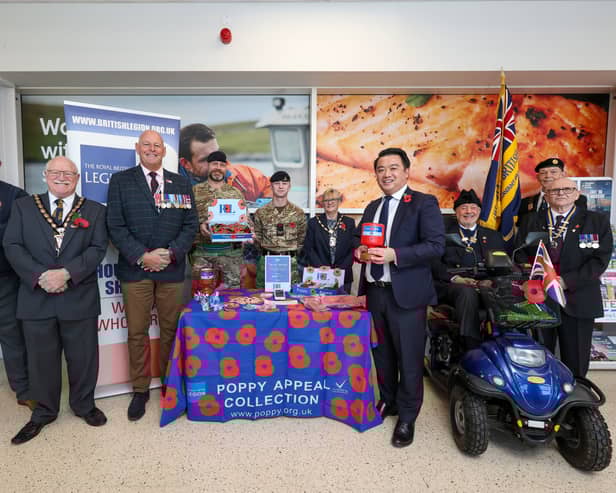 The Havant Poppy Appeal has been launched, with a call for residents to get behind the cause once again. Pictured: Mayor of Havant Cllr Peter Wade, second left, poppy appeal organiser for Havant Andy Carter MBE, third left, Alan Mak MP, fourth from right, Rick Standen who is chair of the Havant branch of the Royal British Legion, right, and others at the launch of the Havant Poppy Appeal at Tesco, Havant
Picture: Chris  Moorhouse (241024-04)