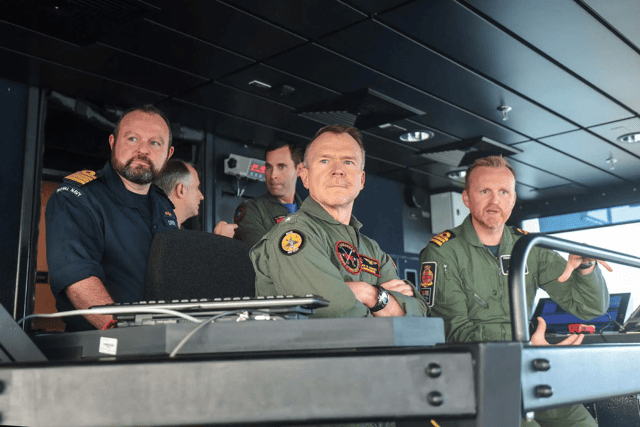 Commander Ian Chuddley welcomes Commander Carrier Strike Group 8, Rear Admiral S Bailey, to witness the launch of the F-35B jets.