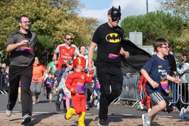 James Furze with his son Ollie running in the Mini South Run on October 19, dressed as Batman and The Flash.