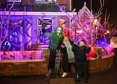 Elliot Smith dressed as a Corn Maze Clown with visitors Penny Unitt and Charlie outside his Halloween house in Stafford.