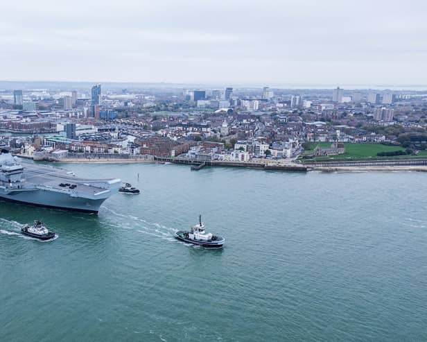 HMS Queen Elizabeth leaving Portsmouth on November 4, 2024, for sea trials. Families gathered along The Hot Walls to watch her depart.