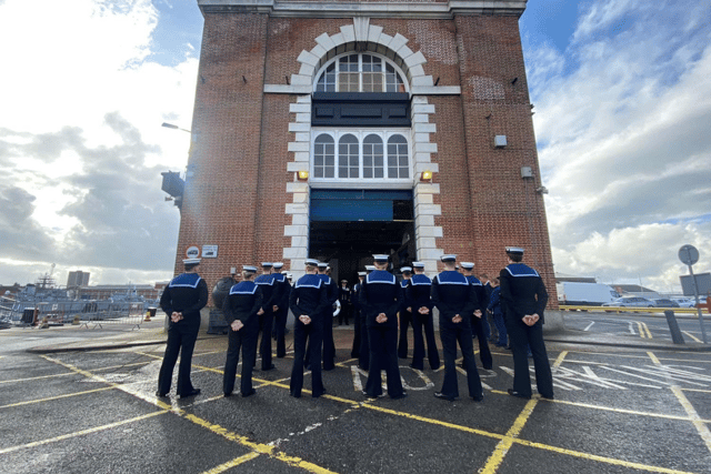 The Royal Navy has disbanded an autonomous systems testing team based in Portsmouth. Pictured are the unit bringing down the White Ensign flag.