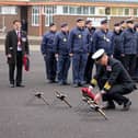The commanding officer of HMS Sultan, captain Mark Hamilton lays a wreath at the Drumhead Ceremony.