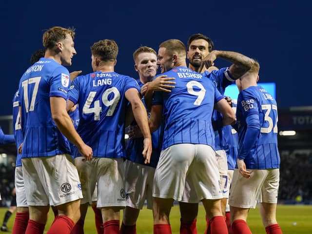 Colby Bishop's team-mates congratulate him on a goalscoring return on a remarkable afternoon at Fratton Park. Picture: Jason Brown/ProSportsImages