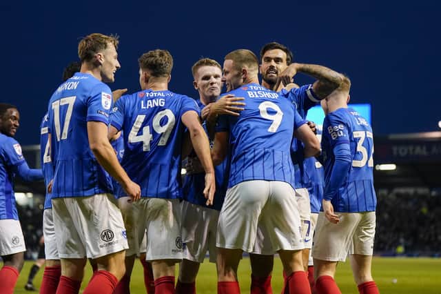 Colby Bishop's team-mates congratulate him on a goalscoring return on a remarkable afternoon at Fratton Park. Picture: Jason Brown/ProSportsImages