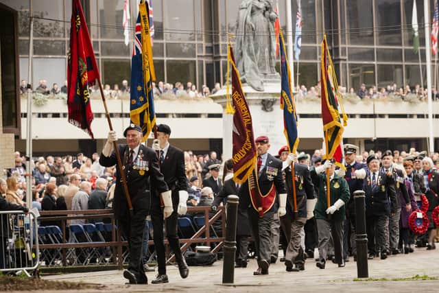 The Standards are marched towards the War memorial in Guildhall Square.