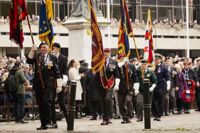 Pictured is: The Standards are marched towards the War memorial on Remembrance Sunday last year.