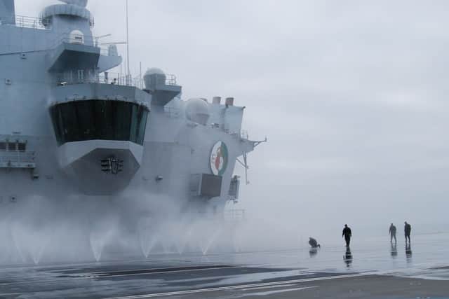 The upper flight deck of HMS Queen Elizabeth was sprayed heavily with water while on sea trials.