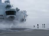 The upper flight deck of HMS Queen Elizabeth was sprayed heavily with water while on sea trials.