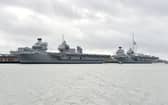 The Times reports that HMS Queen Elizabeth and HMS Prince of Wales would get sunk in most war games scenarios, which the Royal Navy denies.