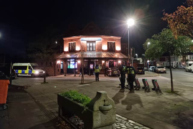 Police standing guard outside The Mermaid pub in New Road, Fratton