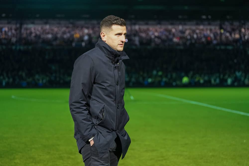 Pompey boss John Mousinho on the pitch waiting to see if the Millwall game will get the go-ahead to be played