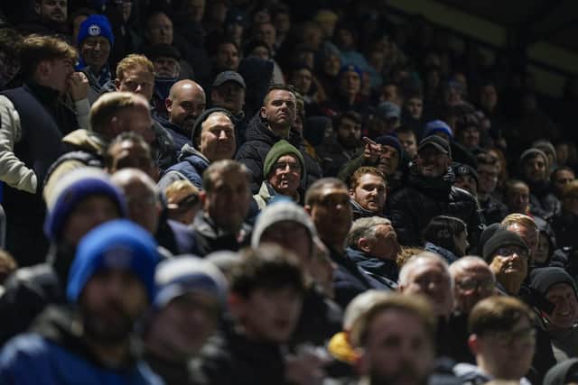 Pompey fans wait for the lights to be switched on Fratton Park on Wednesday night