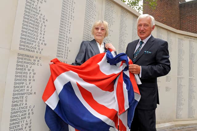 Jean Louth and local businessman Colin Barrell alongside the memorial honouring the city's Second World War dead. The pair are standing next to Jean's late father's name 'H.J.Short' on the memorial on September 9, 2016.