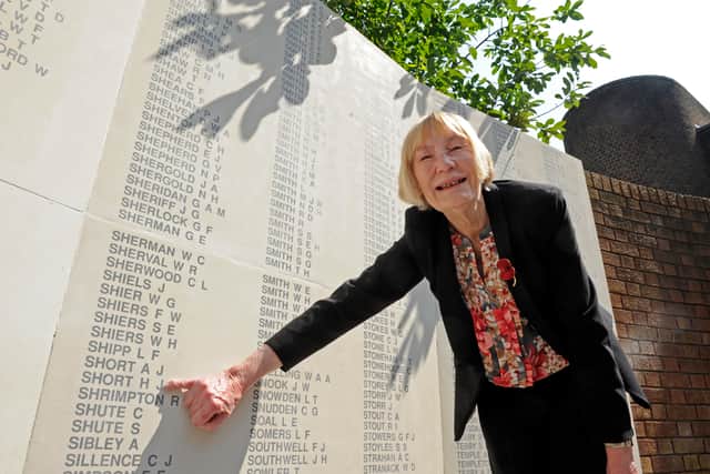 Jean Louth alongside the World War II memorial in Guildhall Square, pointing to her father's name, Harry Short, in 2014.
