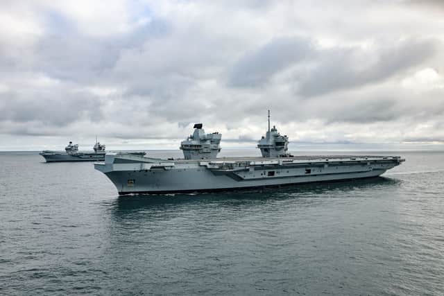 HMS Prince of Wales (front) and HMS Queen Elizabeth at sea