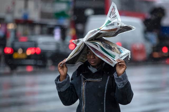 Woman walks in the rain.