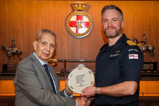 Pictured: Doctor Shiv Pande presenting Captain Will Blackett (Commanding Officer HMS Prince of Wales) with a friendship plate during the freedom of the city parade.