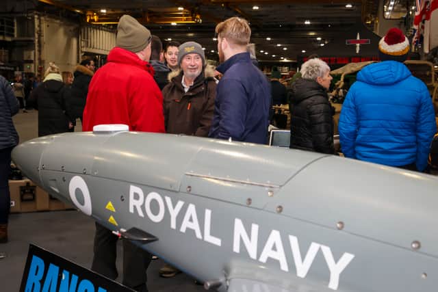 Pictured: Family, friends and members of the public within the HMS Prince of Wales hanger.