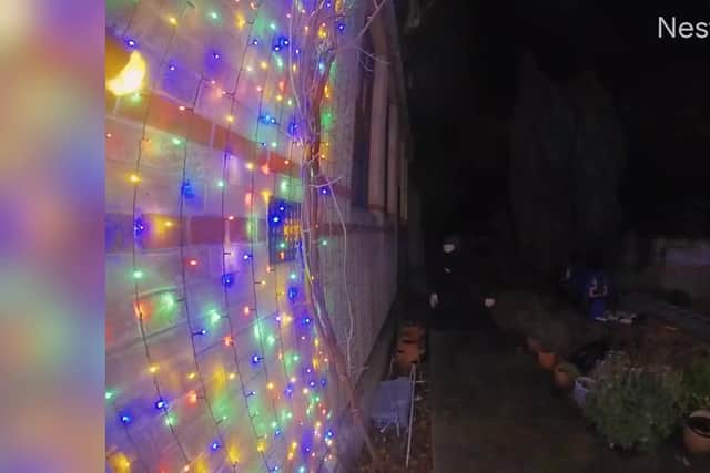 Video grab of a man snipping the Christmas lights at a property in Suffolk.