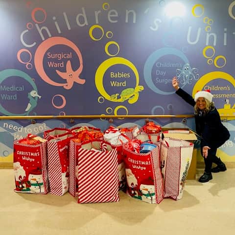 Christian with presents donated to children at QA Hospital on Friday, December 6.