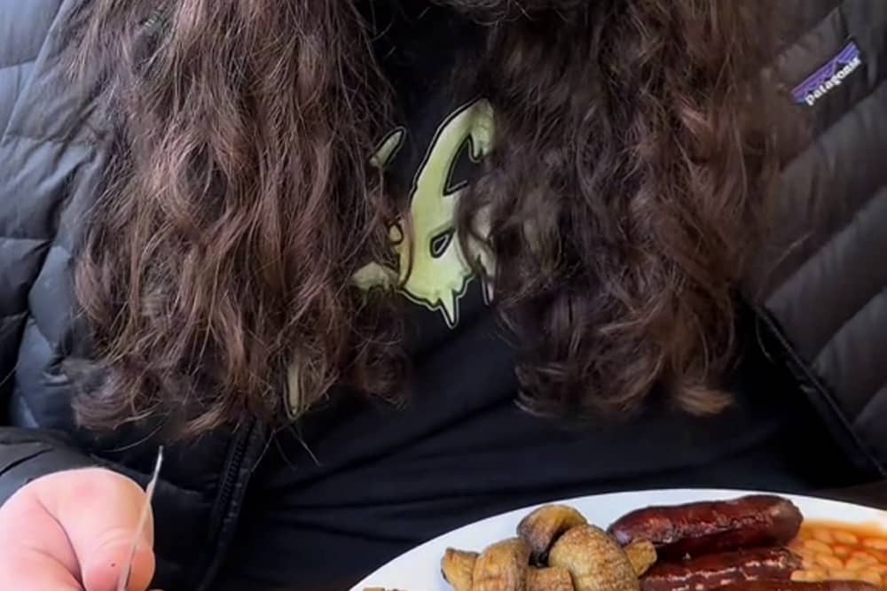 Kalani Smith reviewing a full English breakfast. British cafe goes viral after US TikToker gives glowing reviews of a full English breakfast.