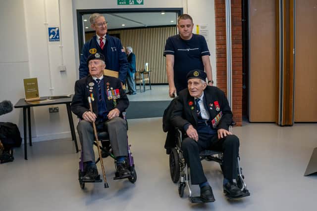 Veterans John Dennett and Stan Ford being brought in to see the new exhibition.