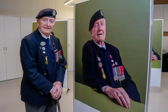 The exhibition, The Lucky Ones Grow Old, features portraits of veterans by Matt Sills taken at The D-Day Story on Wednesday 18th December 2024. Pictured: Cyril Stanley (Stan) Ford alongside his portrait. Picture: Habibur Rahman.