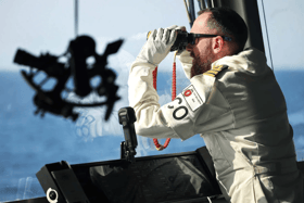 Sailors aboard Portsmouth-based destroyer HMS Diamond have been championed in the New Year's honours list. Pictured: Commander Pete Evans on the bridge of HMS Diamond in the Red Sea.