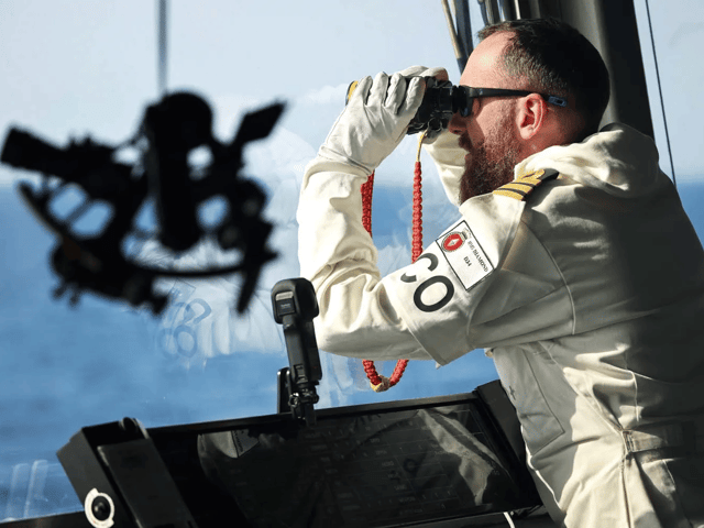 Sailors aboard Portsmouth-based destroyer HMS Diamond have been championed in the New Year's honours list. Pictured: Commander Pete Evans on the bridge of HMS Diamond in the Red Sea.