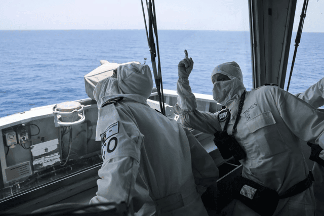 Cdr Pete Evans and Sub Lt James on HMS Diamonds bridge watch a Sea Viper missile intercept an incoming drone.