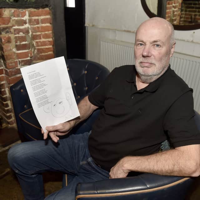 Landlord of The Square Cow in Wickham, Frank Dixie, reads the poem on the returned chair. Picture: Sarah Standing (311224-8143)