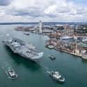 Dockyard workers in Portsmouth have voted to strike due to an ongoing contract row between the Ministry of Defence and Serco for tug and other infrastructure services. Pictured: HMS Prince of Wales leaving Portsmouth Harbour with a tug escort.