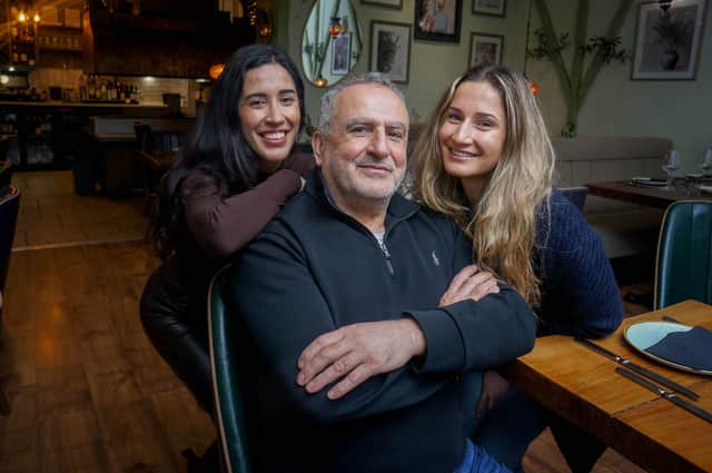 Agora owner Yilmaz Sener, with his twin daughters, Berfin and Dilan Sener in Agora, Southsea