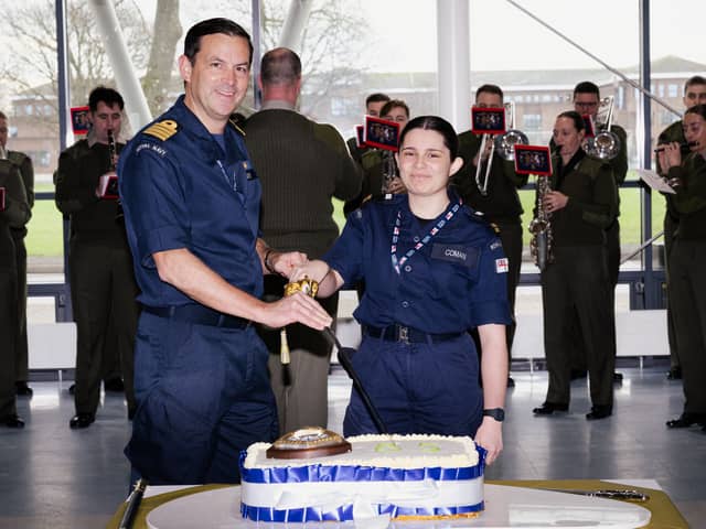 Commanding Officer, Captain Tim Davey, and AB(AWT) Rosie Coman, 16, cutting the cake to celebrate 85 years of HMS Collingwood.