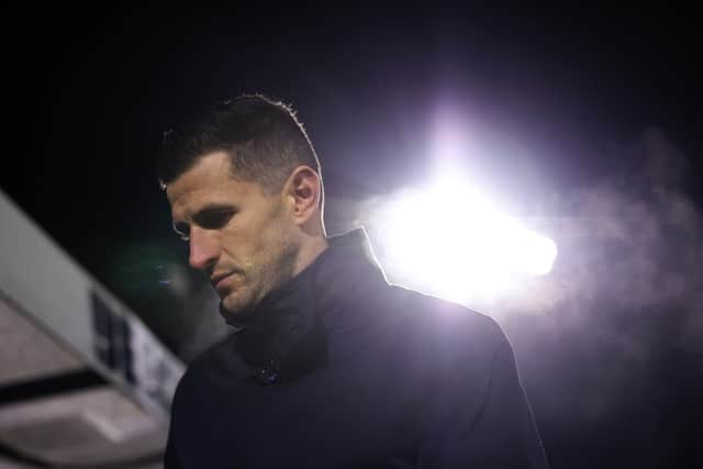 John Mousinho heads for the dressing room at the final whistle