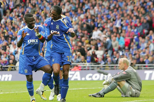 Sulley Muntari celebrates with Pompey goalscorer Kanu in the 2008 FA Cup final win. Picture: CARL DE SOUZA/AFP via Getty Images