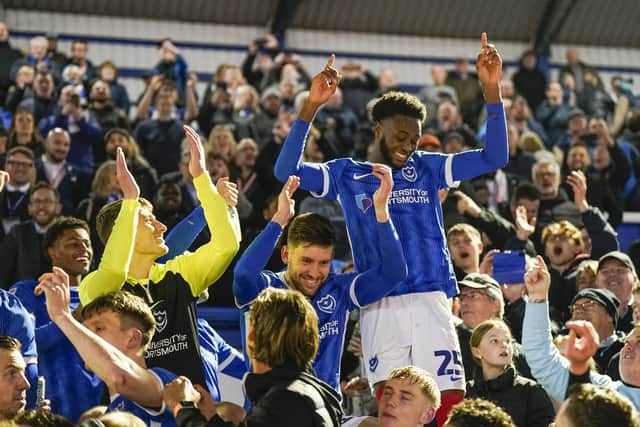 Abu Kamara celebrates Pompey's League One title success at the end of the 2023-24 season with the fans at Fratton Park