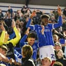 Abu Kamara celebrates Pompey's League One title success at the end of the 2023-24 season with the fans at Fratton Park