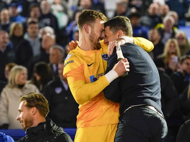 Will Norris and Pompey boss John Mousinho celebrate the League One title win against Barnsley.