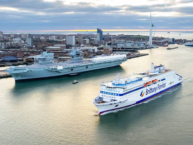 Brittany Ferries' newest vessel, the LNG-powered Saint Malo, sailing into Portsmouth International Port for sea trials - travelling past HMS Prince of Wales.
