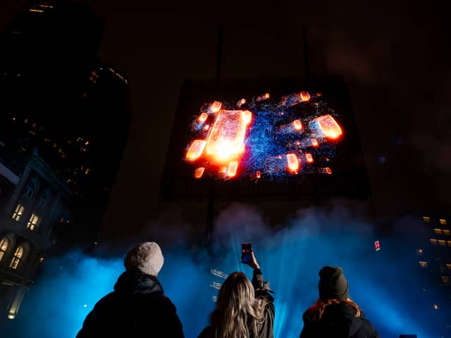 Visuals of a blue whale, northern lights, and football tricks are displayed in a hologram show over London